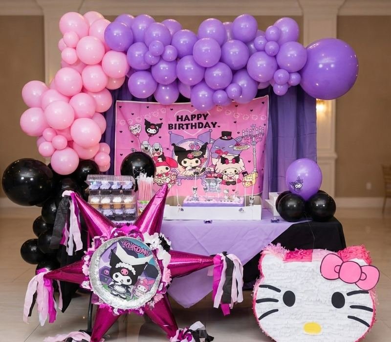 Pink and purple balloon garland with black accents over a Kuromi themed birthday table